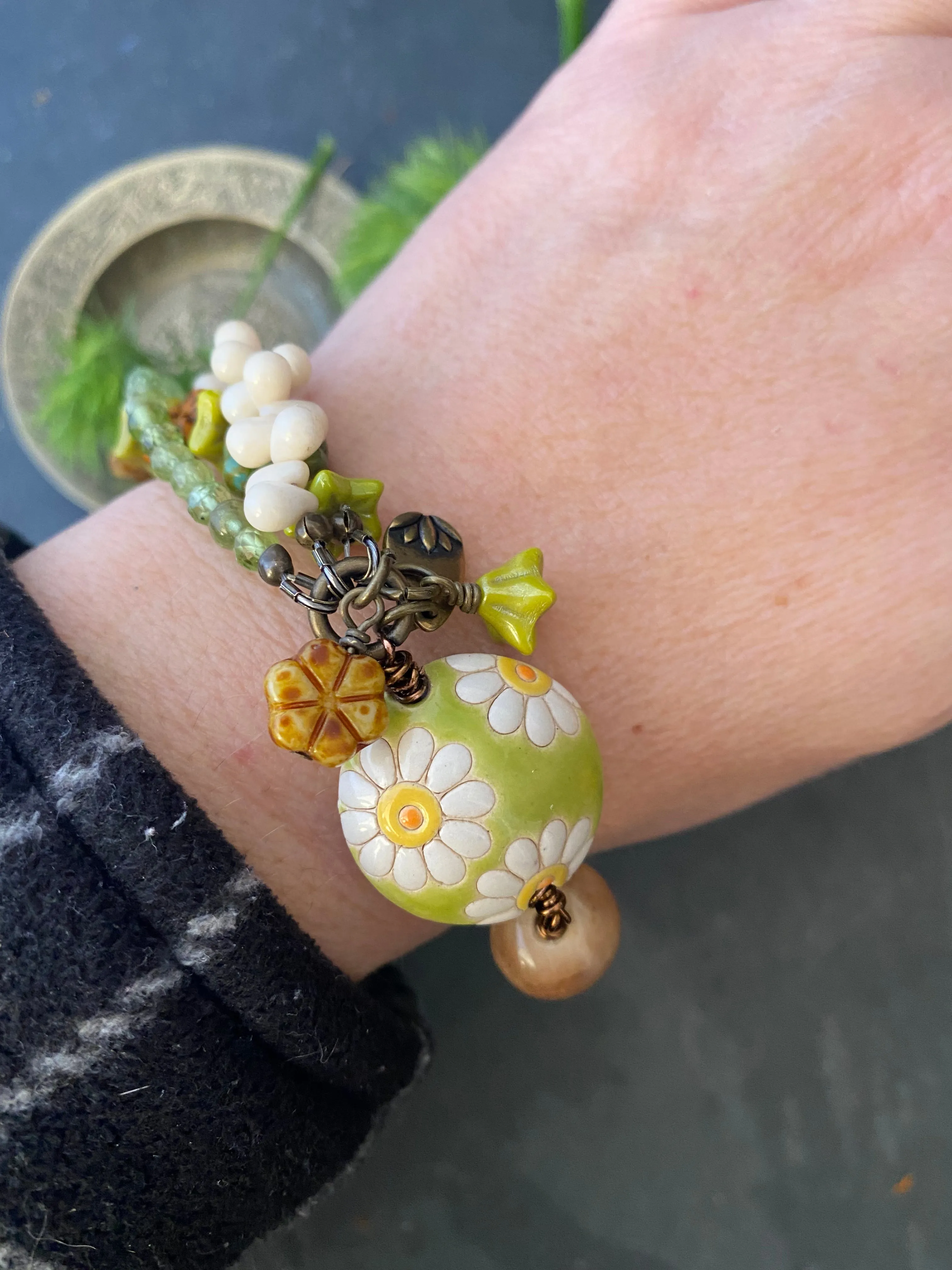 Daisies. Peridot stone, Czech glass flowers, ceramic beads, brinze metal, multi strand, bracelet